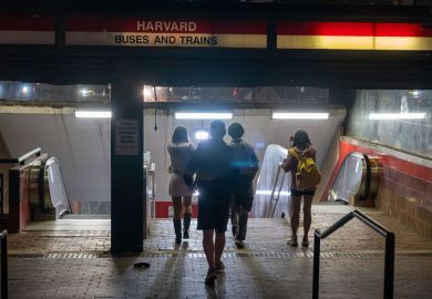 People enter the Harvard transit station on May 27, 2025 in Cambridge, Massachusetts