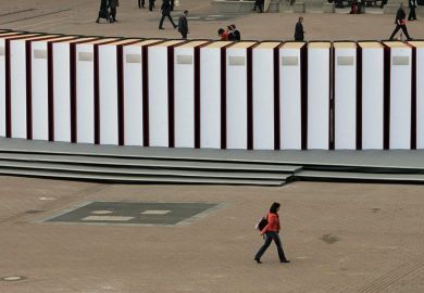 Visitors walk past giant books at the Frankfurt Book Fair. Germany