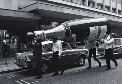 A giant champagne bottle outside the department store Rackhams, Birmingham, UK, 1966. To illustrate high pay for leaders of private UK providers.