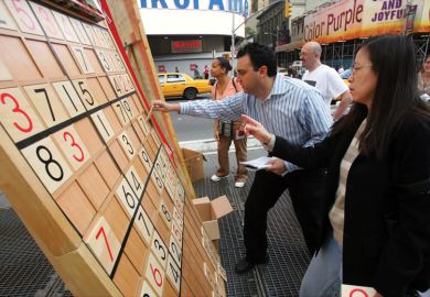 Jim Ressler, owner of Sudoku Board USA, helps Dorris Lam of Glen Rock, N.J., solve a Sudoku puzzle on a gigantic board in Times Square Jim Ressler, owner of Sudoku Board USA, helps Dorris Lam of Glen Rock, N.J., solve a Sudoku puzzle on a gigantic board in Times Square