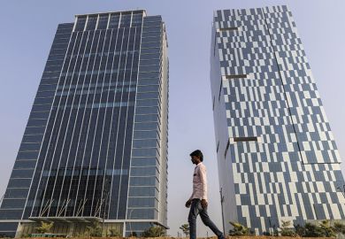 A pedestrian walks past 2 buildings in Gujarat International Finance Tec-City (GIFT City), Gujarat, India A pedestrian walks past 2 buildings in Gujarat International Finance Tec-City (GIFT City), Gujarat, India