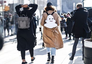 A girl wearing a backpack with a smiley face on it