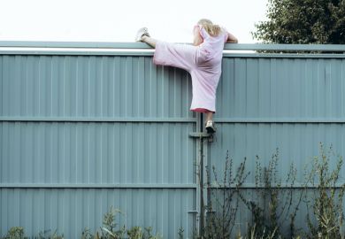 Girl climbing metal fence outdoor