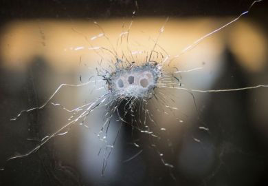 Glass with bullet holes
