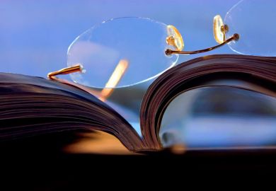 Glasses lying on top of a journal Glasses lying on top of a journal
