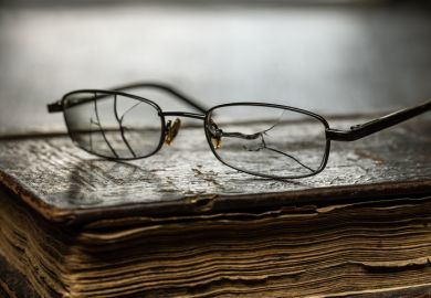 Cracked glasses on an old book, symbolising poor presidential searches