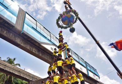 Human pyramid under a globe