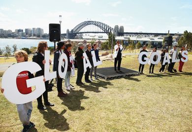 people holding letters spelling GOALS 