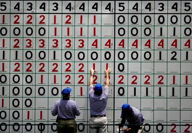 Course volunteers update the main leader board during a golf tournament. To illustrate ‘inconsistency’ fears after REF retreat on environment metrics.