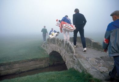 Golfers crossing a bridge in fog