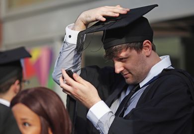 Students adjust their caps ahead of their graduation ceremony, London, UK. To illustrate that over half of graduates regret their undergraduate decisions Students adjust their caps ahead of their graduation ceremony, London, UK. To illustrate that over half of graduates regret their undergraduate decisions