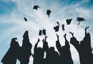 Graduates throw their caps into the air, symbolising the graduate premium Graduates throw their caps into the air, symbolising the graduate premium