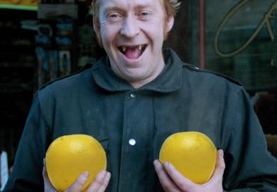 Man holding pair of grapefruit Man holding pair of grapefruit