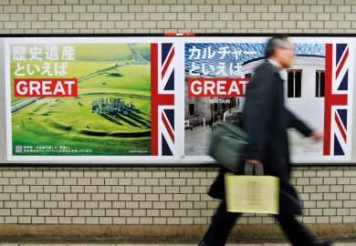 Pedestrian walks past 'GREAT' campaign posters