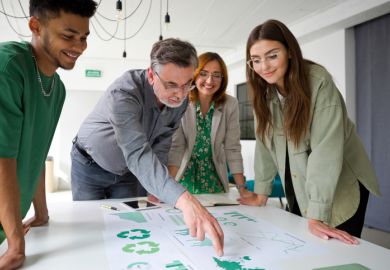 A businessman points at a chart while brainstorming with colleagues, symbolising green business expertise A businessman points at a chart while brainstorming with colleagues, symbolising green business expertise