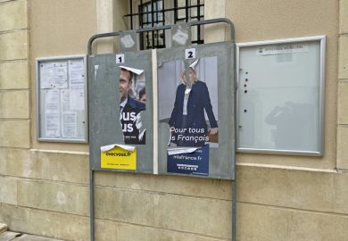 Gréoux-les-Bains, France - April 24, 2022 Torn France presidential election posters showing politicians Emmanuel Macron and Marine Le Pen.