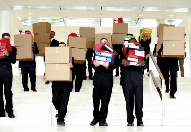 Group of businessmen carrying boxes from office