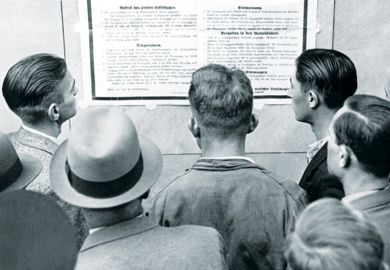 Group of men reading from notice board Group of men reading from notice board