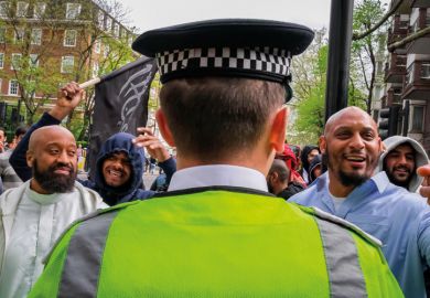 Group of muslim men and British police officer
