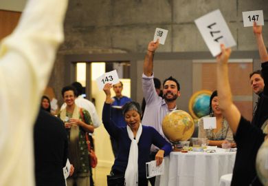 Group of people bidding at auction