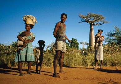 Group of people standing near baobab trees, Madagascar