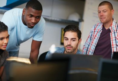 Group of students looking at computer monitor Group of students looking at computer monitor