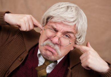 Grumpy man with fingers in ears