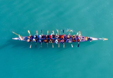 Haifa, Israel - December 11, 2020 Dragon Boat team rowing to the pace of an onboard Drummer