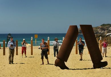 Steel sculpture 'Pedestrian Portrait' at Tamarama Beach, Sydney, Australia. The sculpture shows just a pair of lower legs, illustrating that there has been a spike in the number of student visa applications to Australia that have been withdrawn.