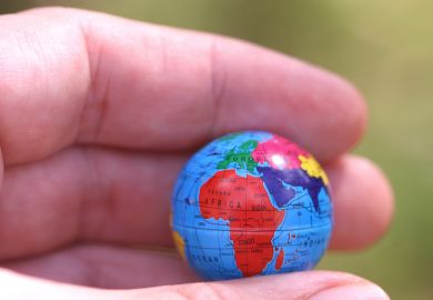 Hand holding globe showing Africa