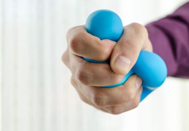 Hand squeezing stress ball Hand squeezing stress ball