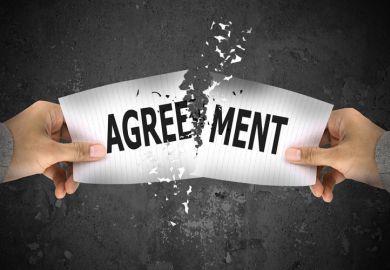 Hands ripping up paper agreement Hands ripping up paper agreement