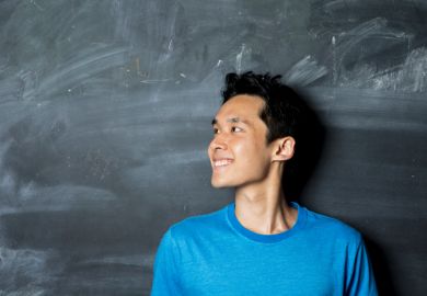 Student in front of blackboard