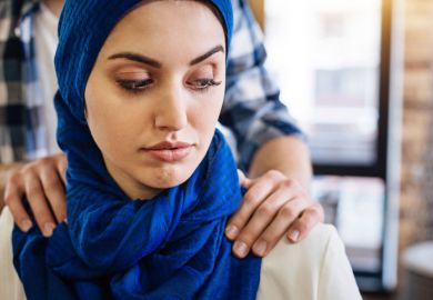 A Muslim woman with male hands on her shoulders A Muslim woman with male hands on her shoulders, signifying sexual harassment in the Middle East