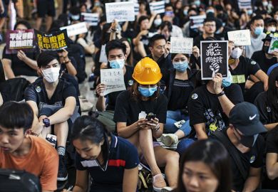 Woman in hard hat amid Hong Kong protest