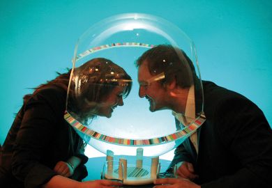 Two volunteers try out the 'social sphere' for two - plastic speech bubbles that allow you to hold a private conversation in noisy pubs and clubs