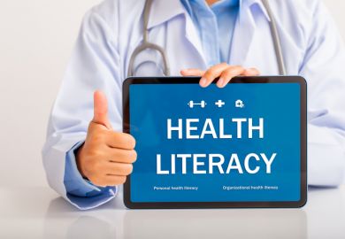 A doctor holding a "health literacy" sign A doctor holding a "health literacy" sign
