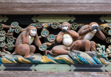 Monkeys in the "hear no evil" pose