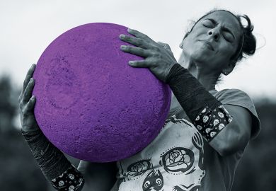 woman lifts heavy ball woman lifts heavy ball