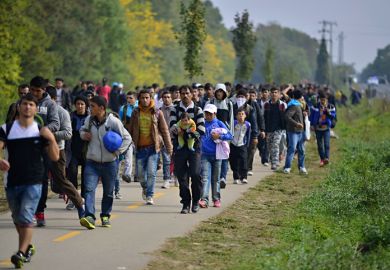 Hegyeshalom, Hungary - October 6, 2015 Group of refugees leaving Hungary. They came to Hegyeshalom by train and then they leaving Hungary and go to Austria and then to Germany. Many of them escapes from home because of civil war.