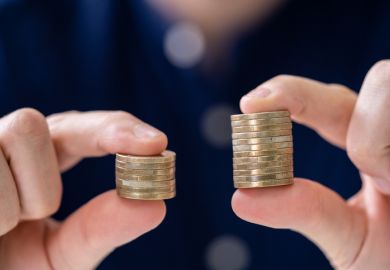 Holding Two Coin Stacks