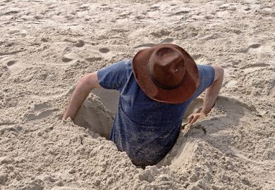 Man buried to waist in sand Man buried to waist in sand