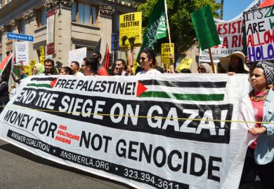 Hollywood, CA,, USA - August 16, 2014 Protestors with signs and flags march along Hollywood Boulevard behind a banner which reads, End The Siege On Gaza on August 16, 2014 in Hollywood, California.