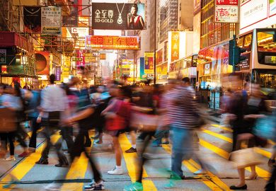 Motion Blurred Pedestrians walking over a busy crosswalk in Hong Kong Motion Blurred Pedestrians walking over a busy crosswalk in Hong Kong