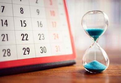 hourglass and calendar, illustrating delays in decisions over research funding grants