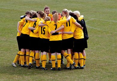 Women`s football team huddle before match