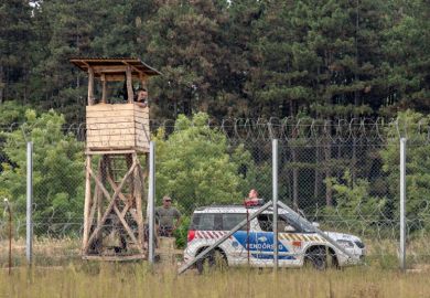  September 10, 2016: Hungarian policemen watching the Serbia Hungarian border fence