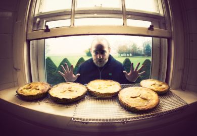 Hungry man looking longingly at row of pies