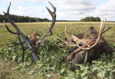 Hunting trophies of elk and deer with weapons after the hunt, symbolising the pursuit of large grants