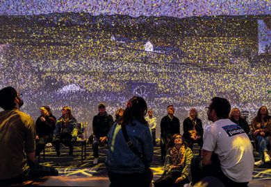 Audience watching an Immersive experience Audience watching an Immersive experience to illustrate a better, faster way to find survey participants